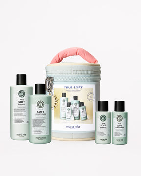 Maria Nila hair care products including bottles and a travel case on a white background