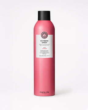 Pink hair spray bottle with black cap on a white background
