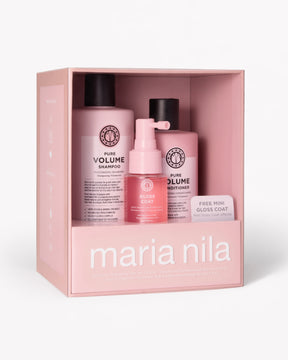 Maria Nila hair care gift set in a pink box, containing a Volume Shampoo bottle, a Volume Conditioner bottle, a Gloss Coat pump bottle.