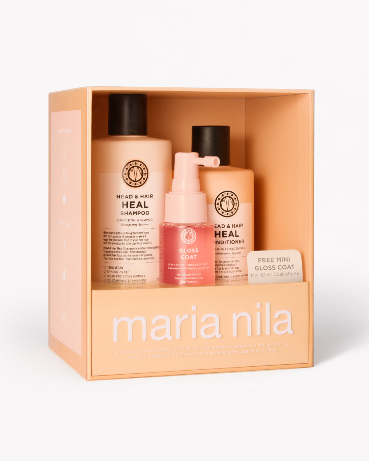Maria Nila Head & Hair Heal gift set in a peach-colored box, containing a shampoo bottle, a conditioner bottle, a pink mini gloss coat spray bottle. 