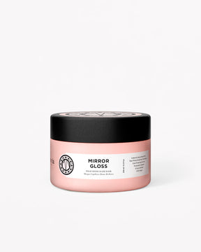 Pink jar with black lid labeled 'Mirror Gloss hair mask' on a white background