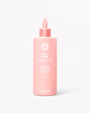 Pink bottle of Maria Nila Gloss Rinse on a white background