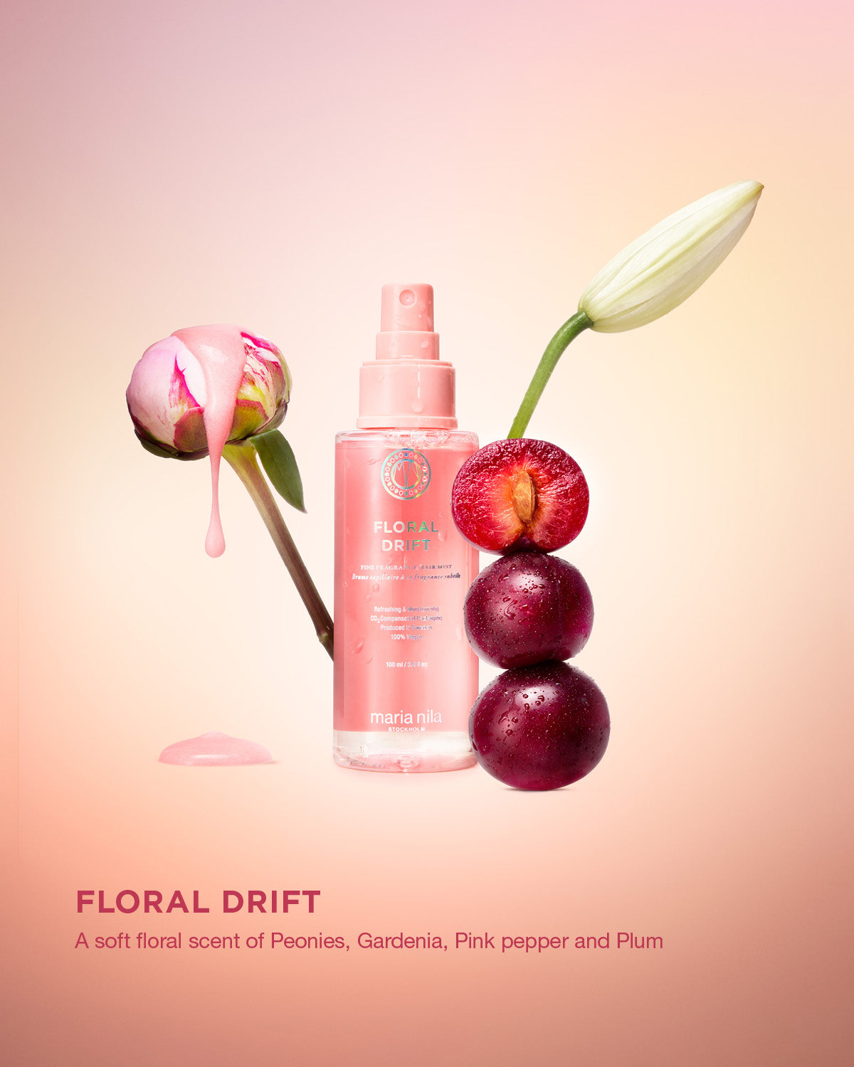 Pink bottle labeled 'Floral Drift' with flowers and plums on a gradient background