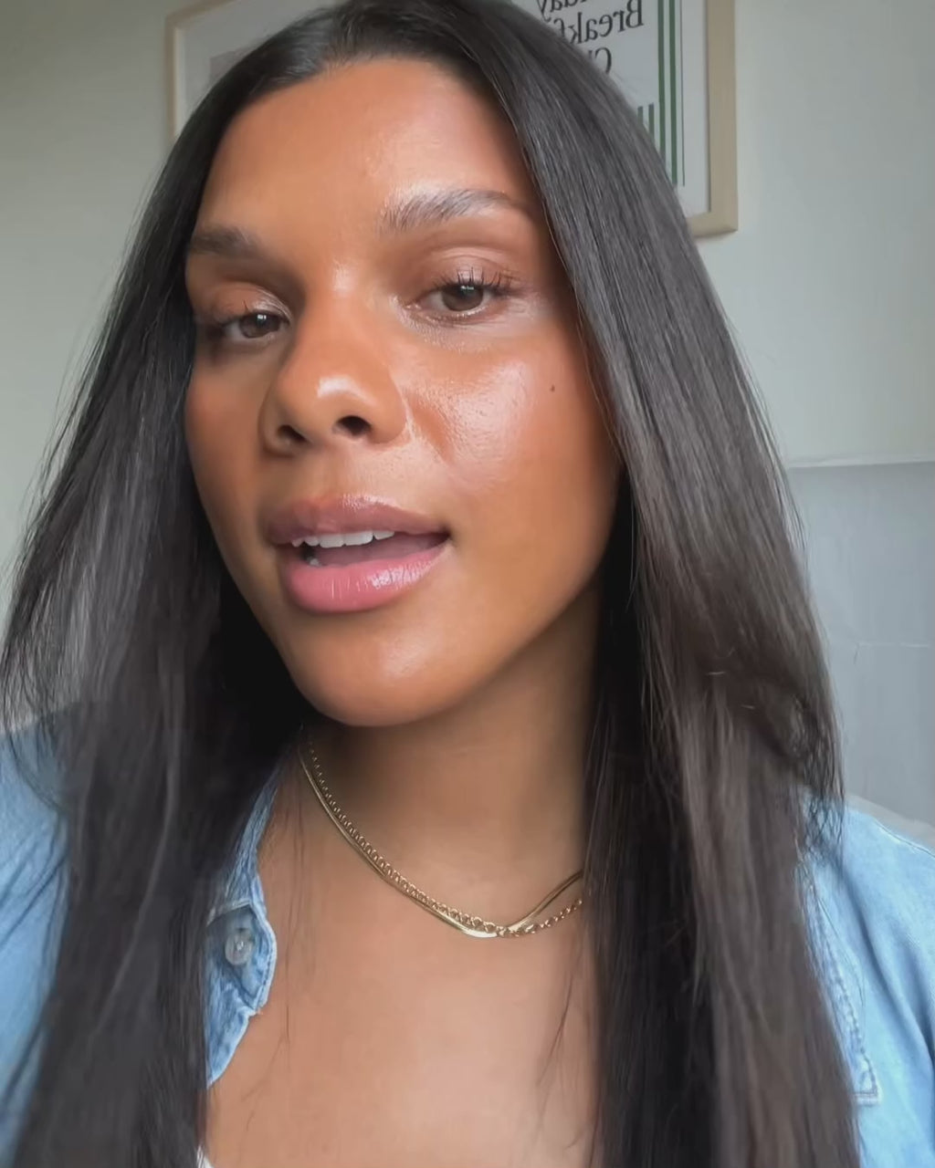 Woman with dark hair using the Maria Nila Gloss Coat